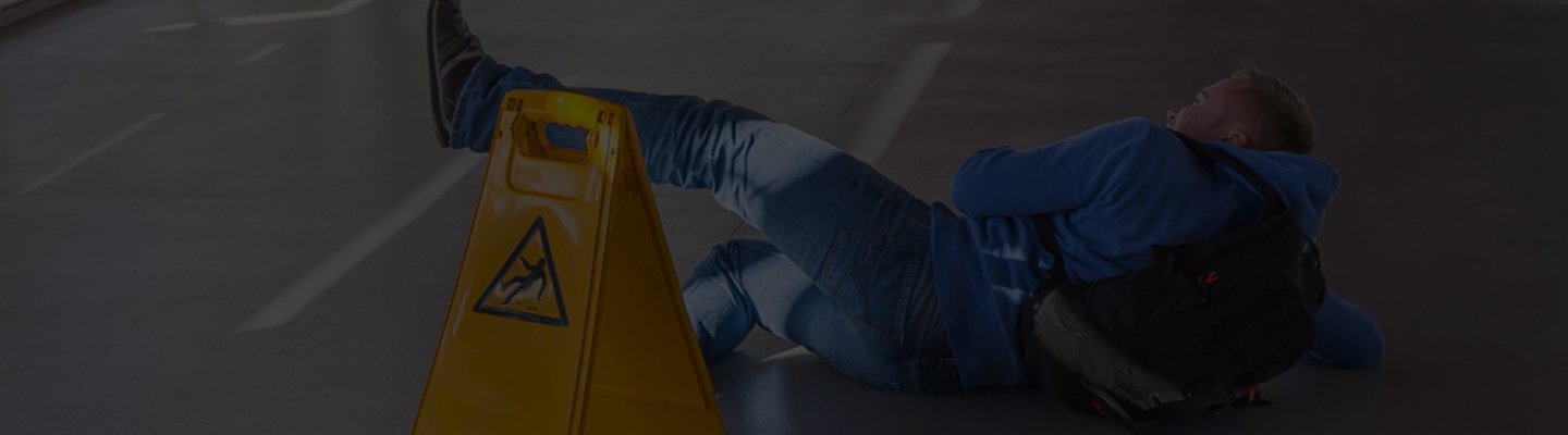 caution cone with man falling