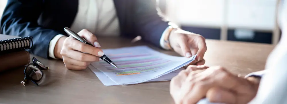 An attorney explaining a highlighted and marked up legal document to a client